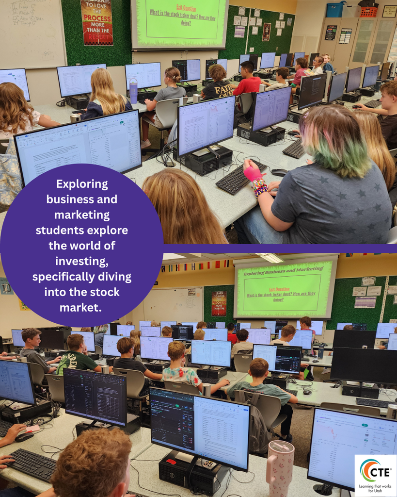 students in front of computers discussing stock market and business