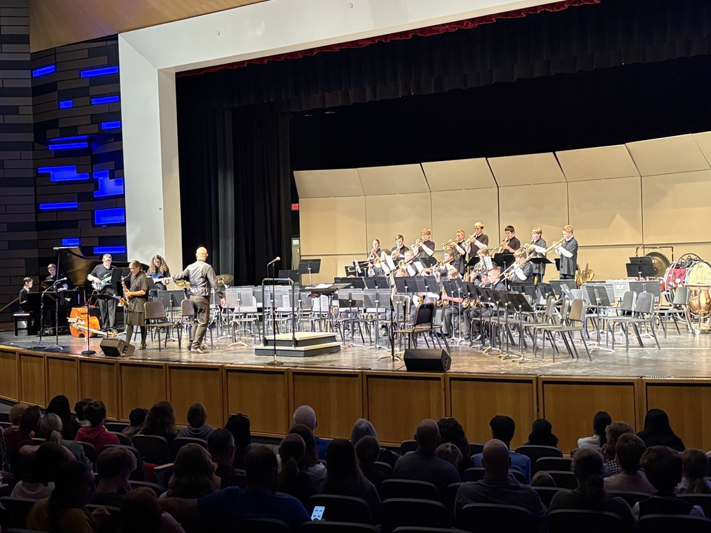 An image of the Millcreek Jr High  bad being conducted by Mr. Frohm. The students are in dress clothes. dresses and vests and ties. 