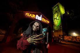 Image of skeleton in front of a sign saying "Fear Factory" staring at the camera