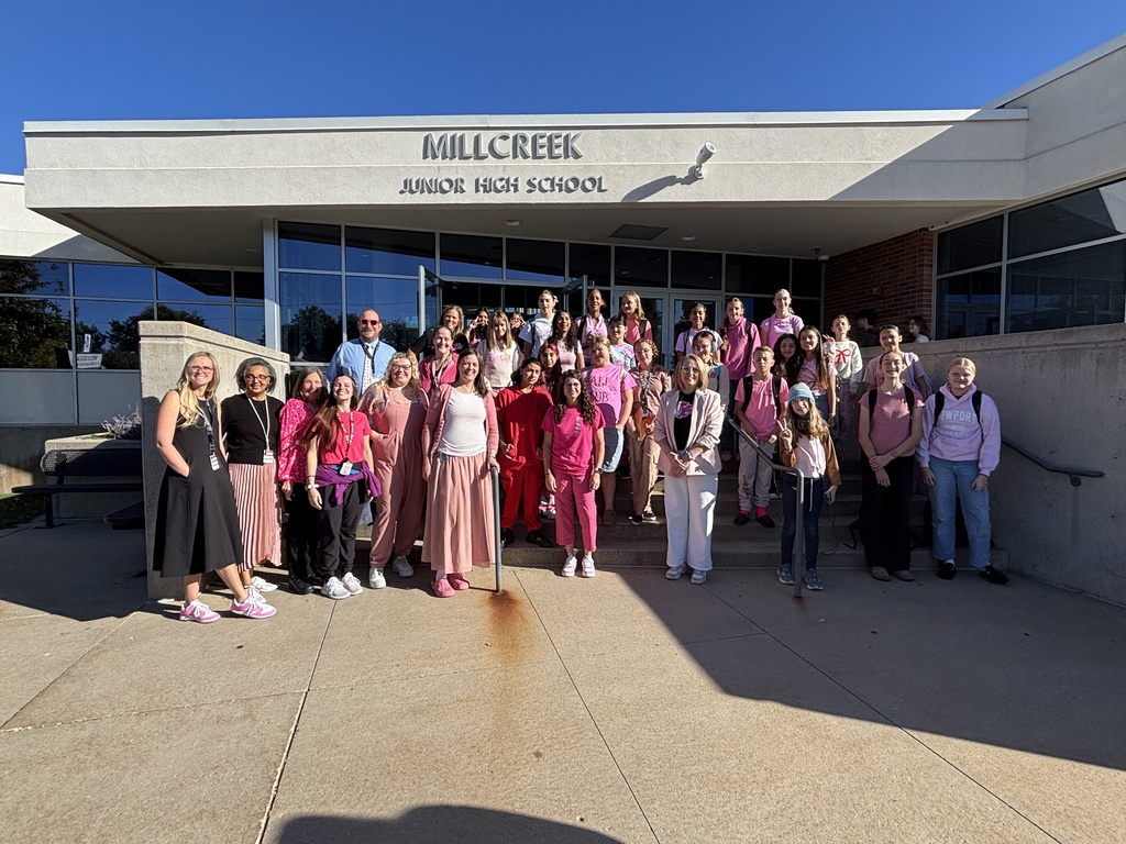an imagge of some of our faculty and staff wearing various shades of pink to support the volleyball team.