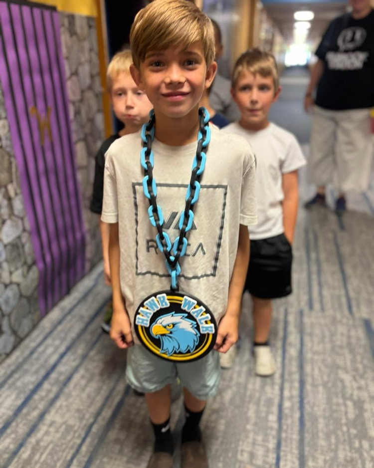 Student wearing our Hawk Walk award!