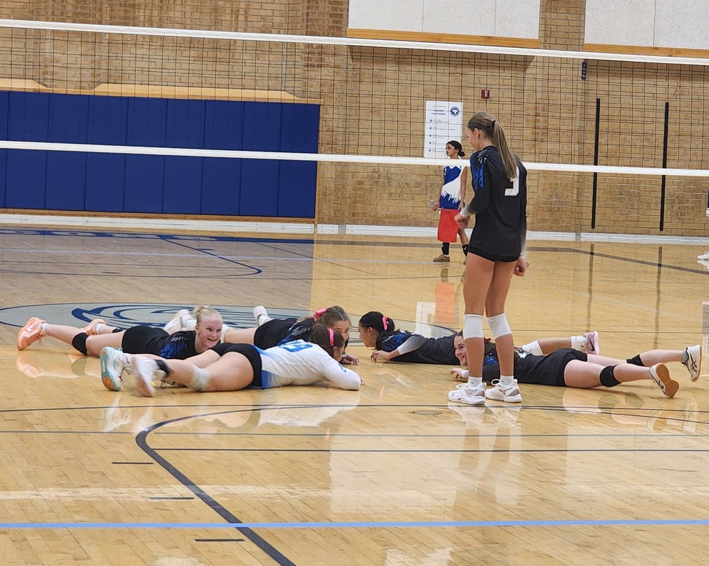 Fairfield's team is celebrating a service 'Ace' by moving like crabs on the ground, with the server dancing.