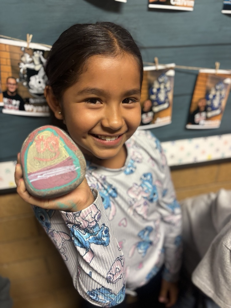 Girl holding painted rock