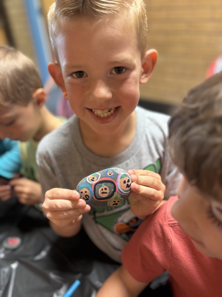 Boy holding painted Rock