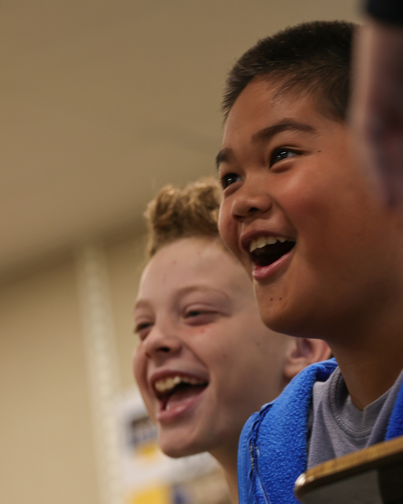 Two students smiling in awe.