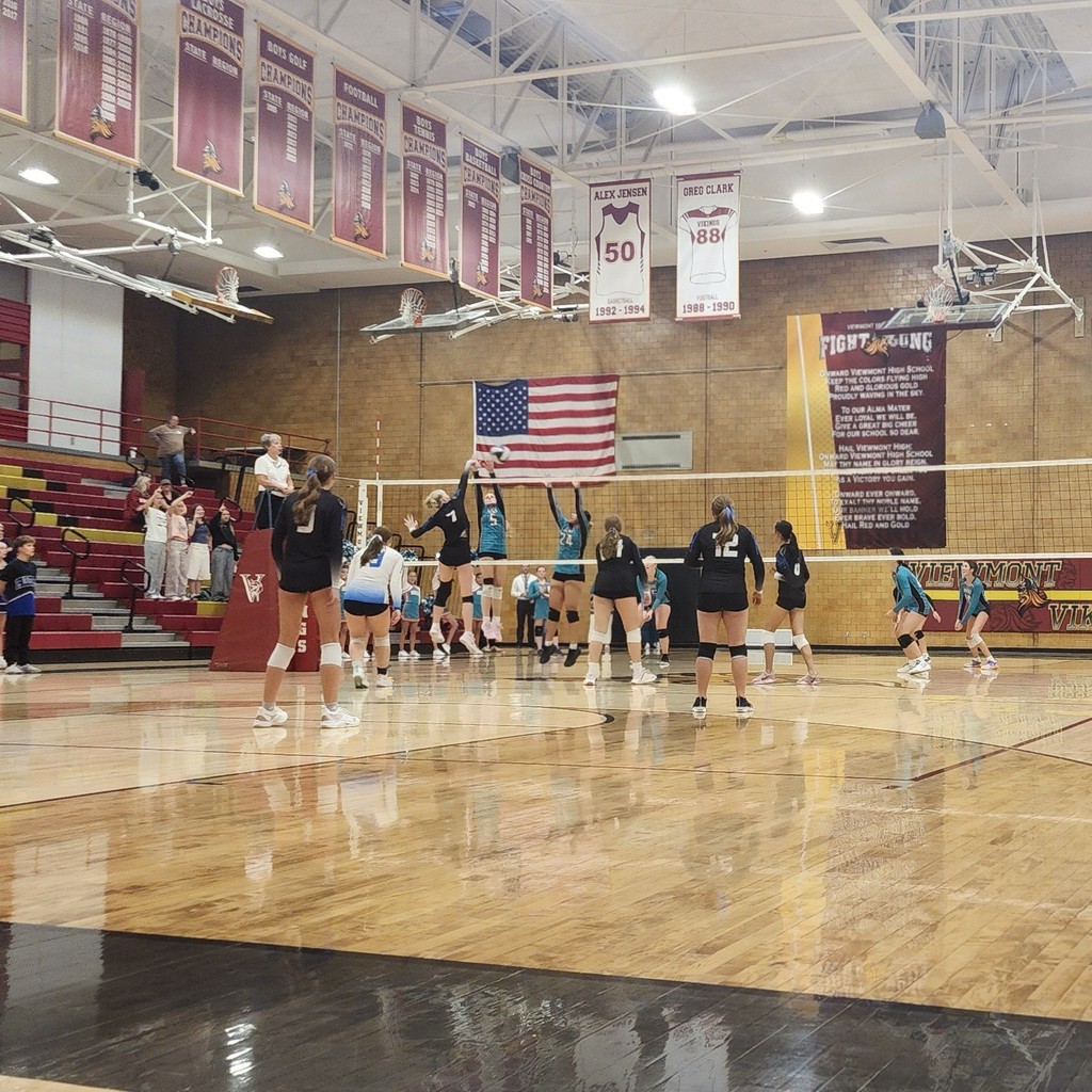 Fairfield's hitter is attacking the ball into two of Horizons blockers.  Fairfield is on the near side of the net, Horizon is on the far side.