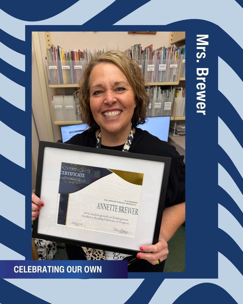 Mrs. Brewer Holding a certificate from Davis School District.