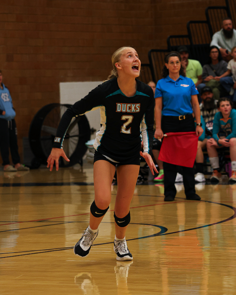 A Horizon Junior High volleyball player yells mid-run as the ball comes her way.