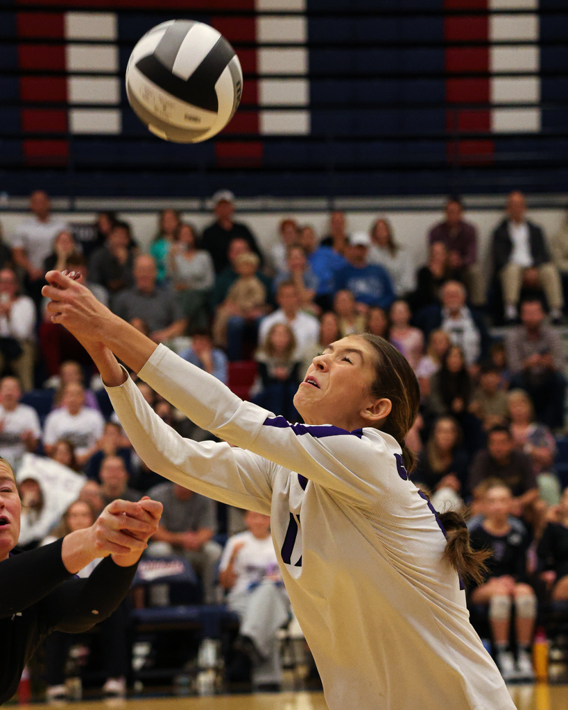 A Centennial Junior High volleyball player digs a volleyball.