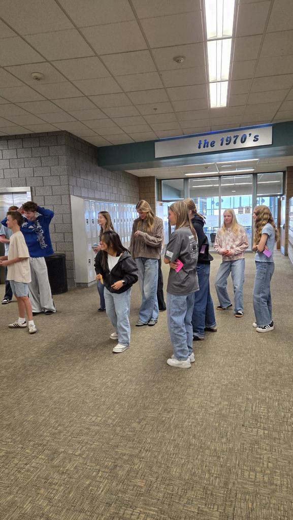 students in a group talking for a game