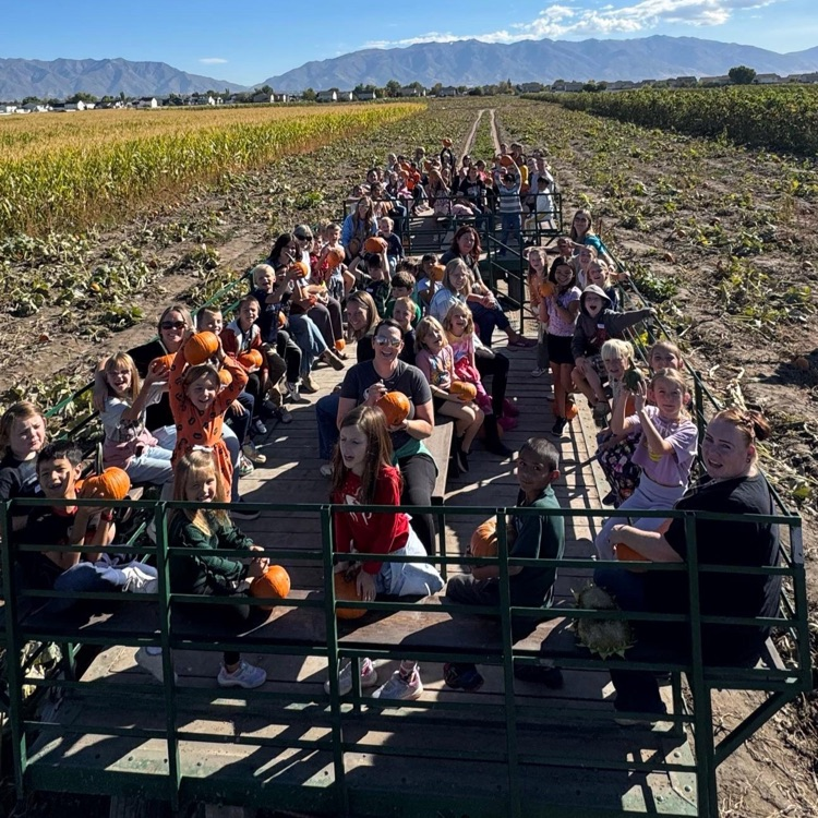 Group of kids enjoying a hayride with their pumpkins!