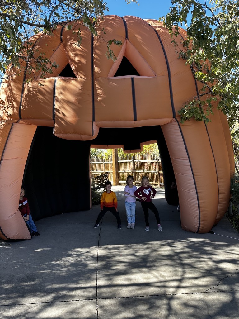 students pictured in an inflatable pumpkin