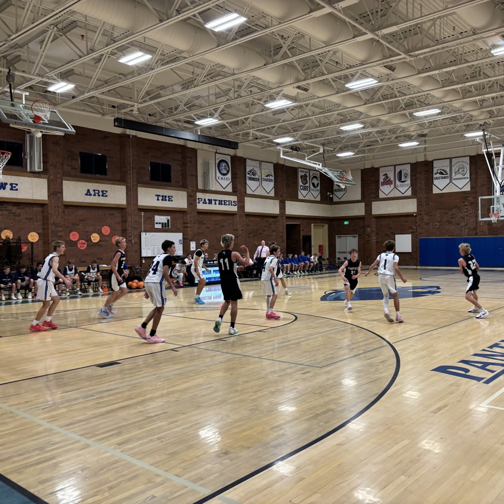 Fairfield Basketball, in Black, is competing with Mueller Park in White