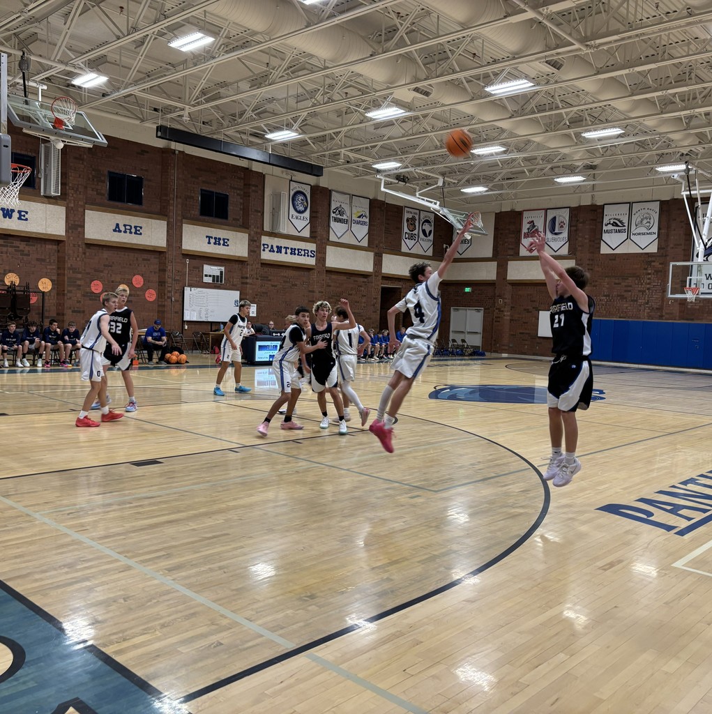 Fairfield Basketball, in Black, is competing with Mueller Park in White