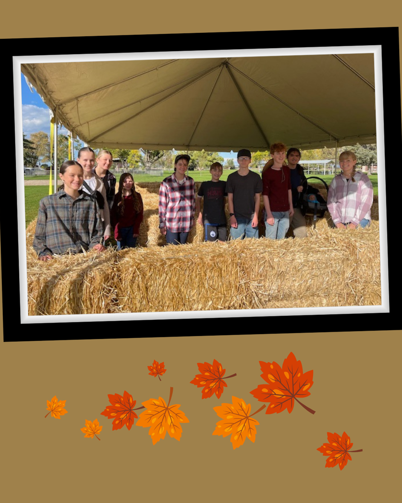 National Honor Society posing in a Hay Maze they created.