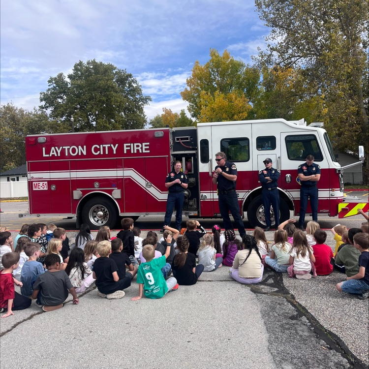 Firemen talking to students in front of a firetruck!