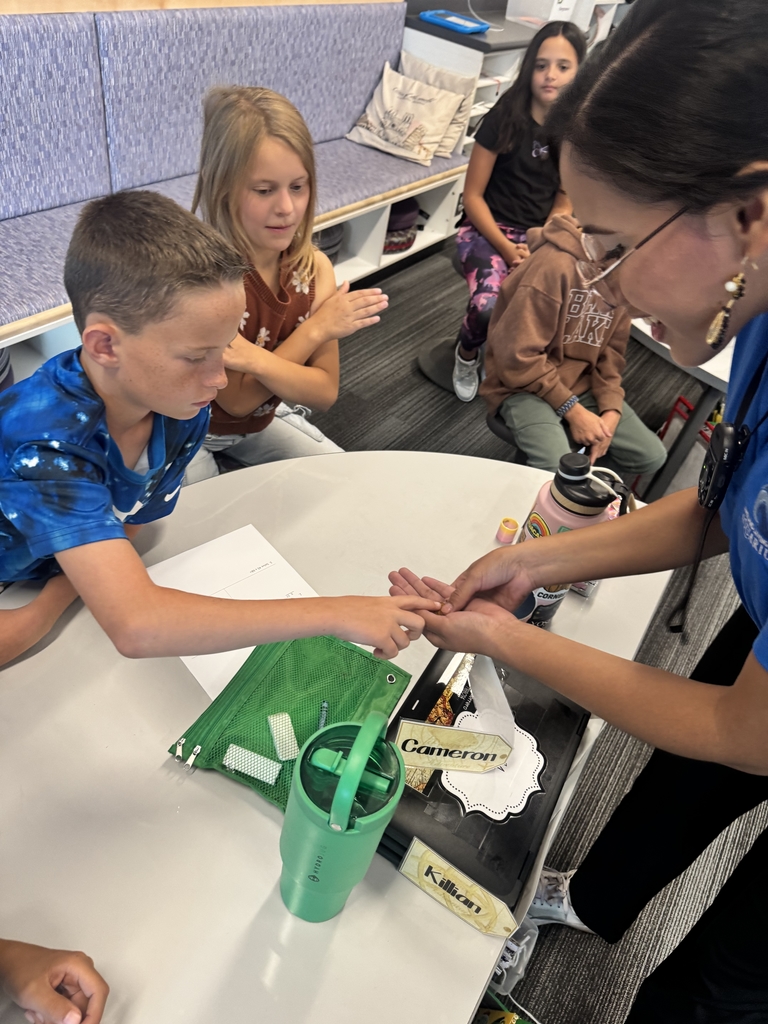 boy touching something in womans hands and a girl making an x with her arms