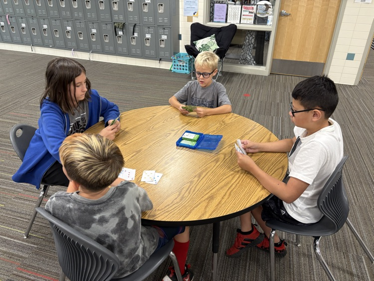 second and fifth grade buddies playing math games
