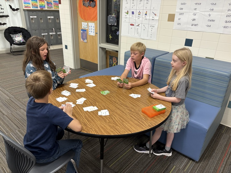 second and fifth grade buddies playing math games