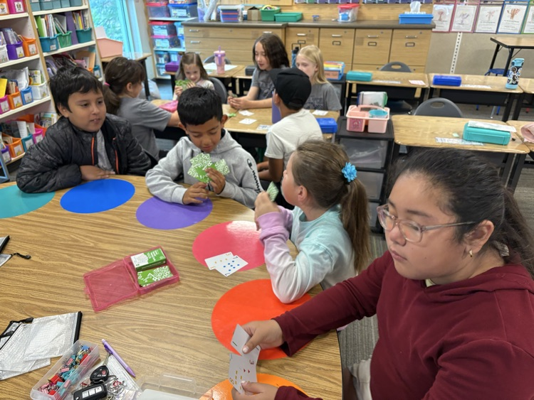second and fifth grade buddies playing math games