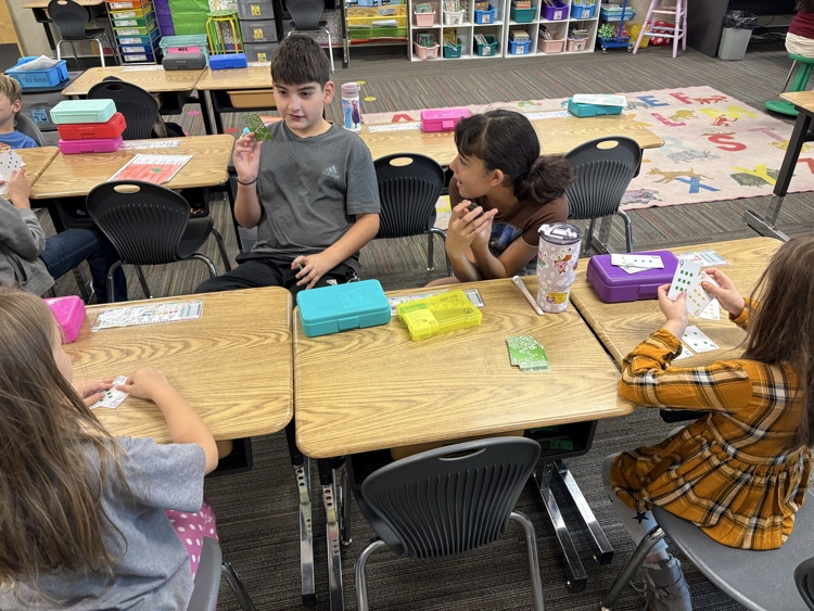second and fifth grade buddies playing math games