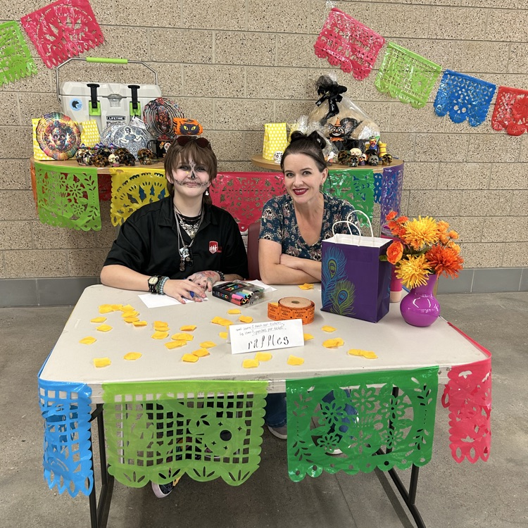 Two people sitting at a table with colorful flags