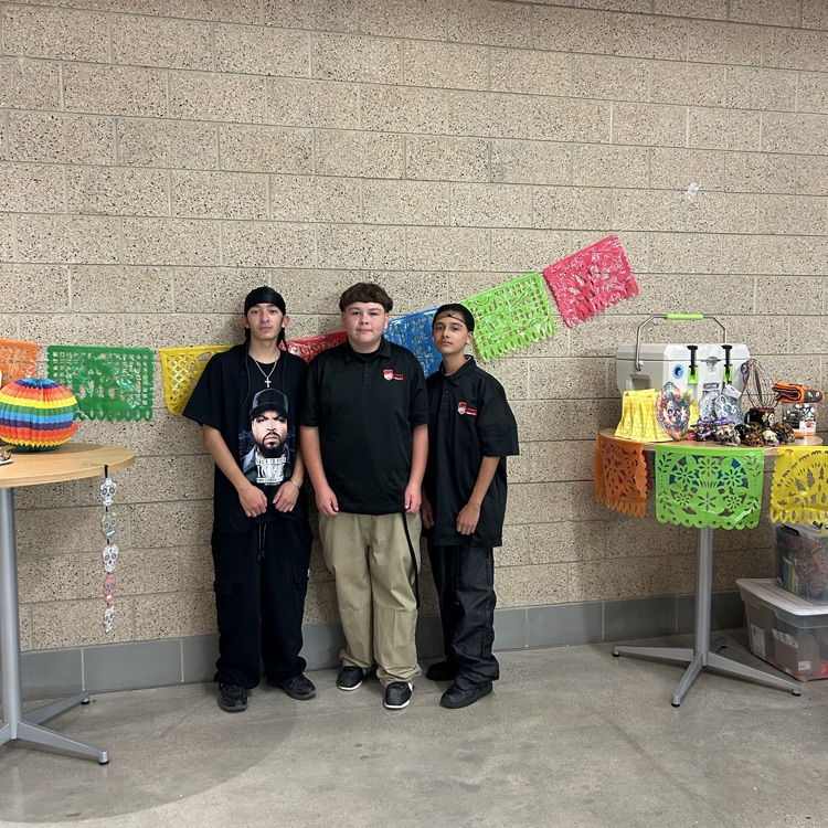 Three boys standing by a decorated table