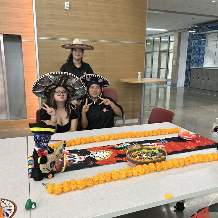 Three students wearing sombreros