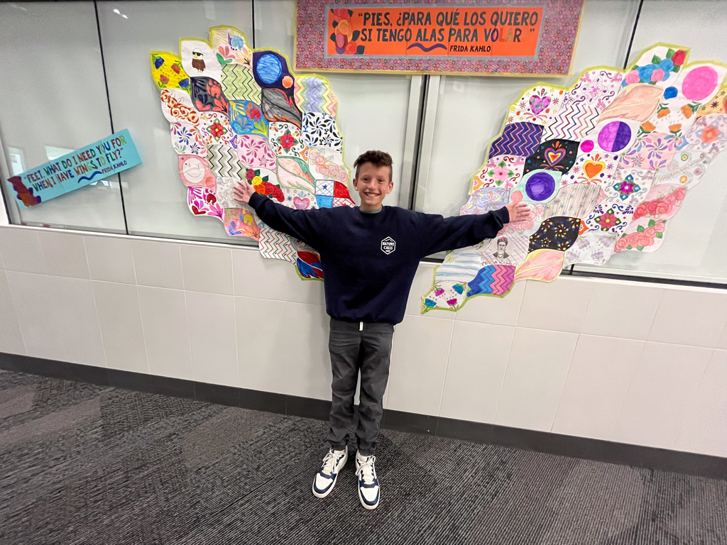 A student holding his arms out wide.