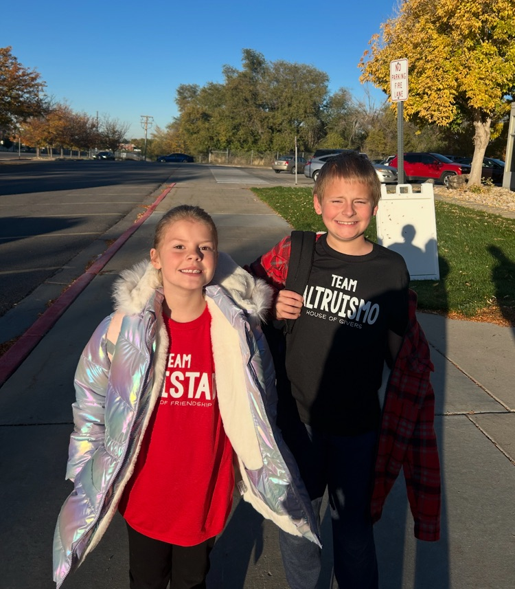 siblings showing off new house shirts 