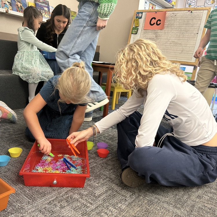 FFJH cheerleaders playing with elementary student