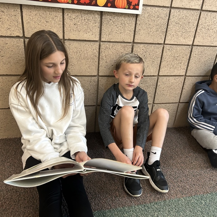 FFJH cheerleaders playing with elementary student