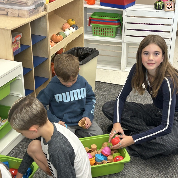 FFJH cheerleaders playing with elementary student