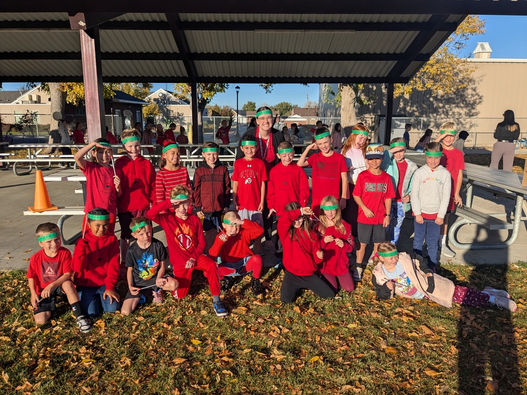 2nd grade students posing for a picture with their teacher. All students wearing a laurel leaf headband. 
