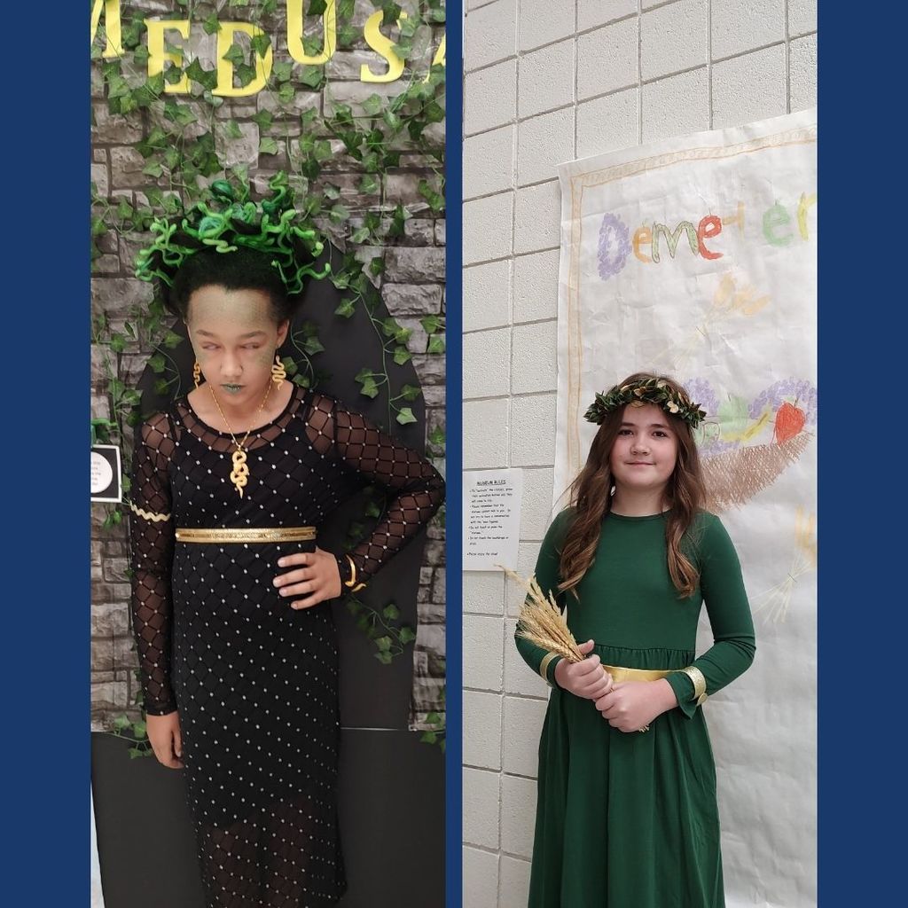 Students dressed as ancient characters with decorated backgrounds.