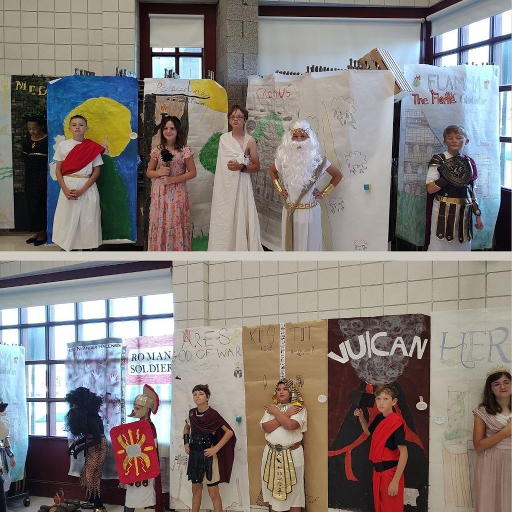 Students dressed as ancient characters with decorated backgrounds.