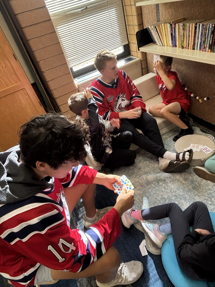 students playing math games with Ogden Mustang hockey team.