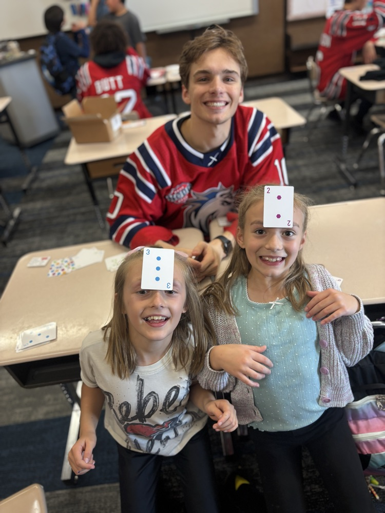 students playing math games with Ogden Mustang hockey team.