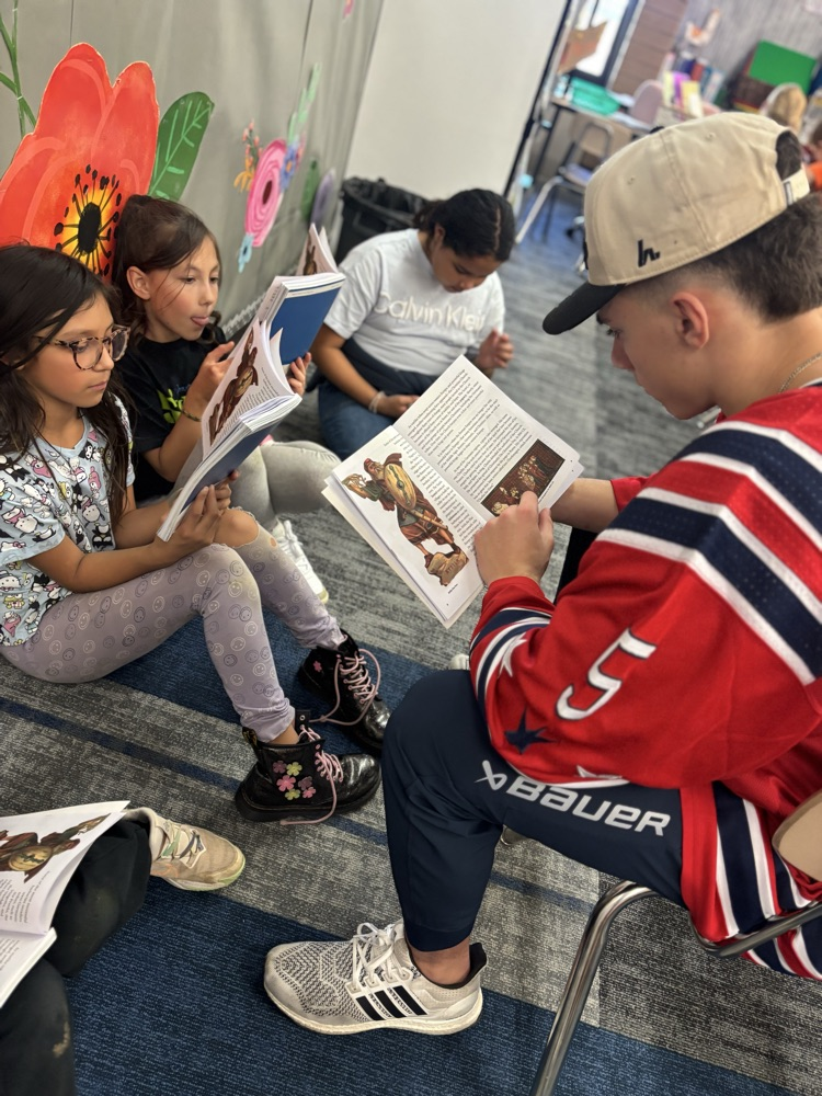 students reading with Ogden Mustang hockey team.