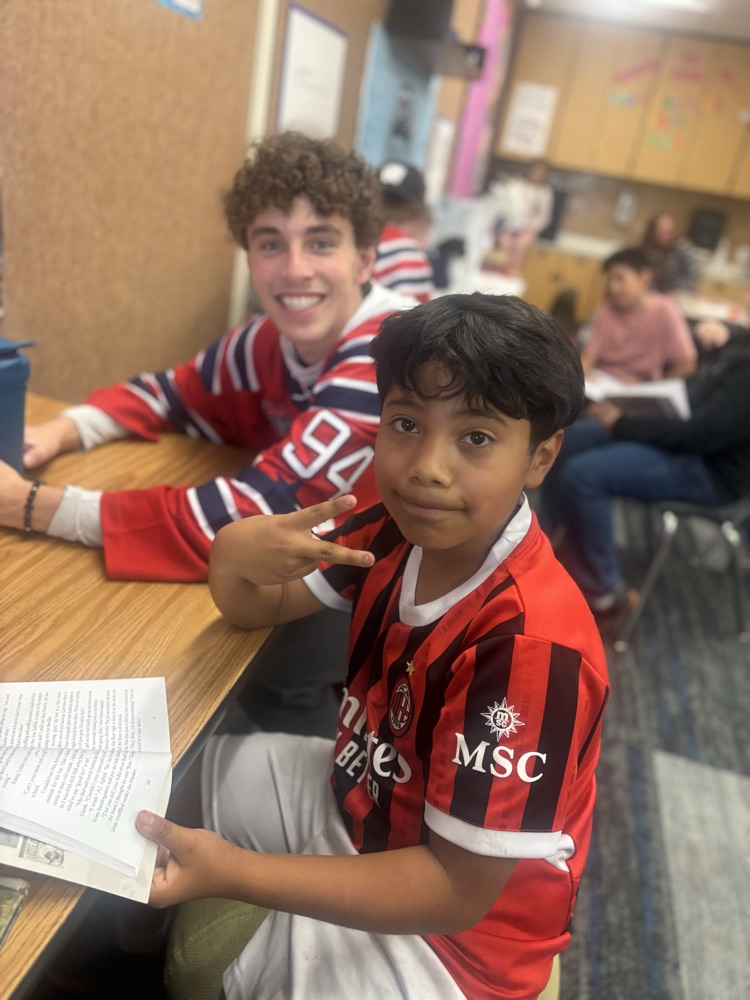 students reading with Ogden Mustang hockey team.