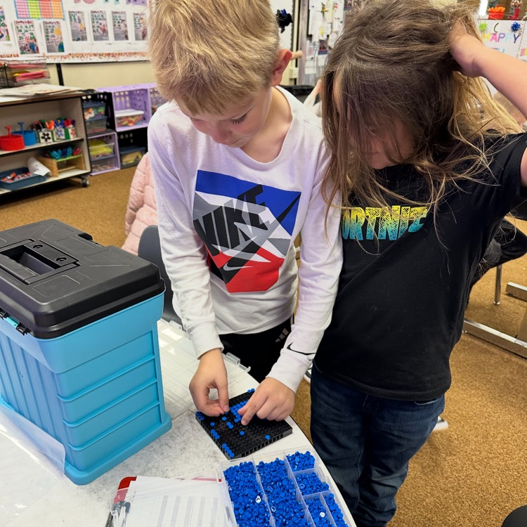 students picking Lego pieces 