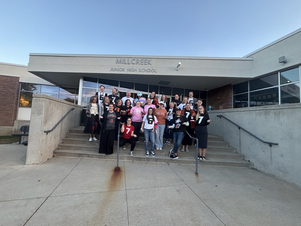 an image of some of our faculty and staff wearing either a six or a seven on their t shirts