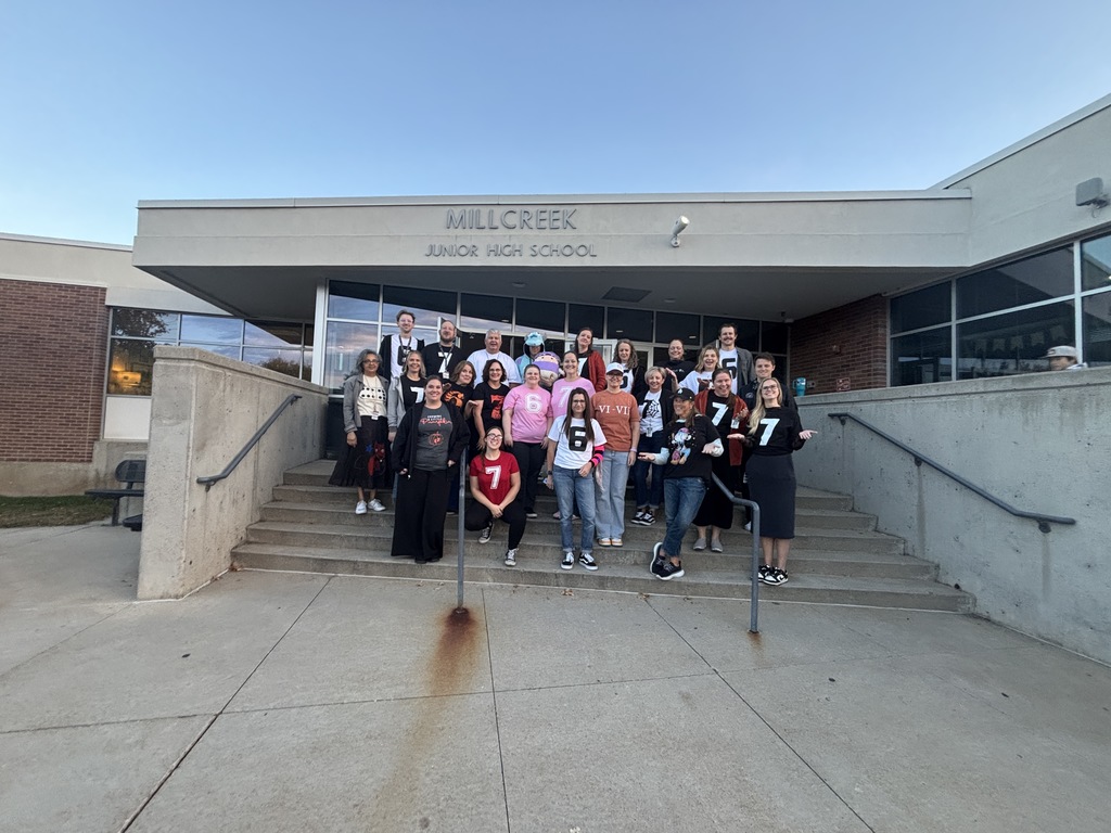 an image of some of our faculty and staff wearing either a six or a seven on their t shirts.