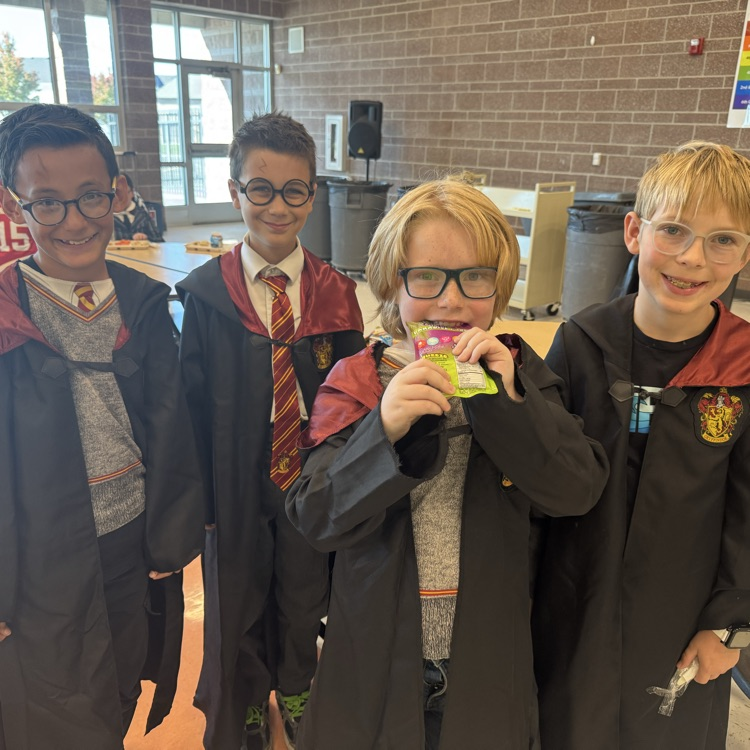 Four students dressed like wizards