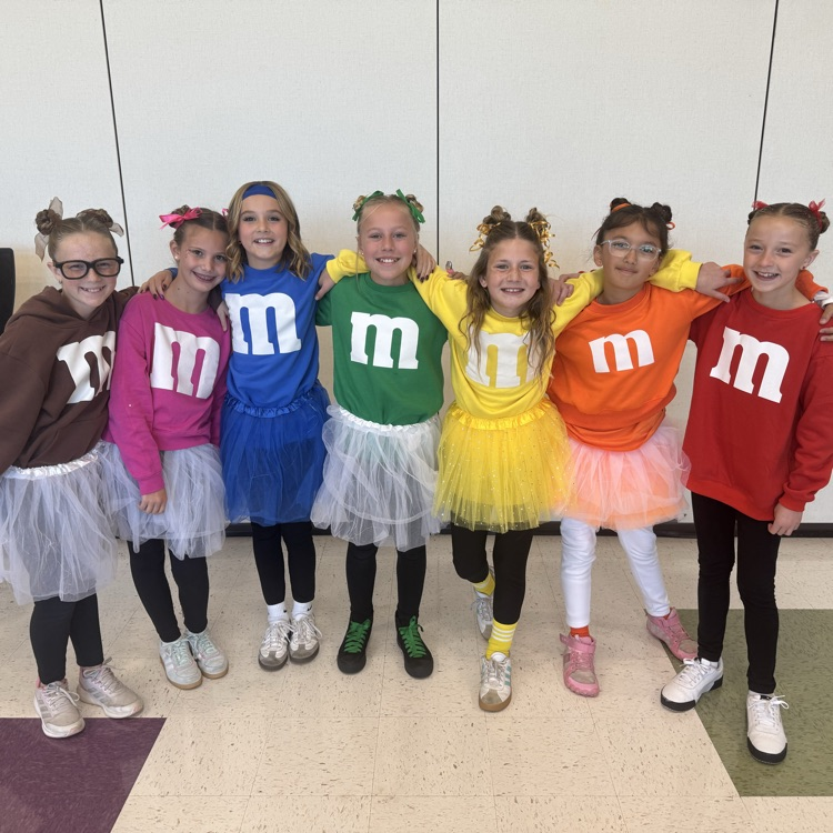 Six girls dressed like M&Ms