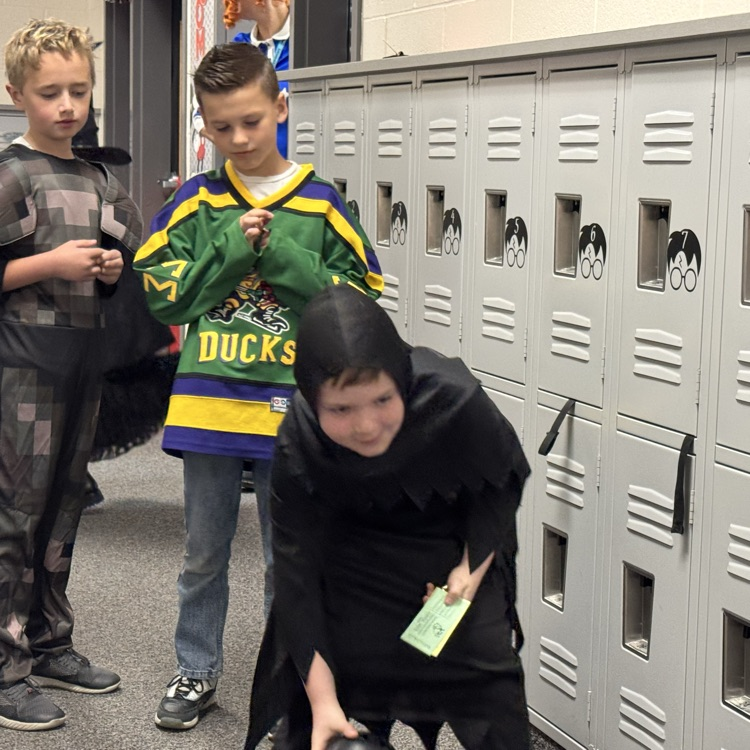 Students in costume bowling at Halloween party