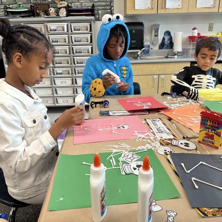 Students working on a craft during Halloween party
