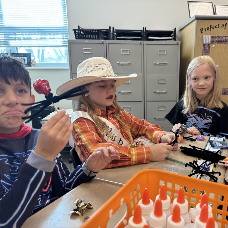Students working on a craft at Halloween party