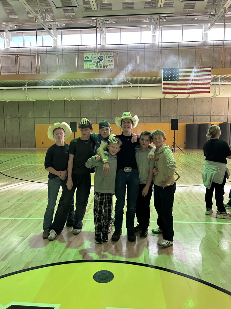 Boys posing at the dance in the gym.