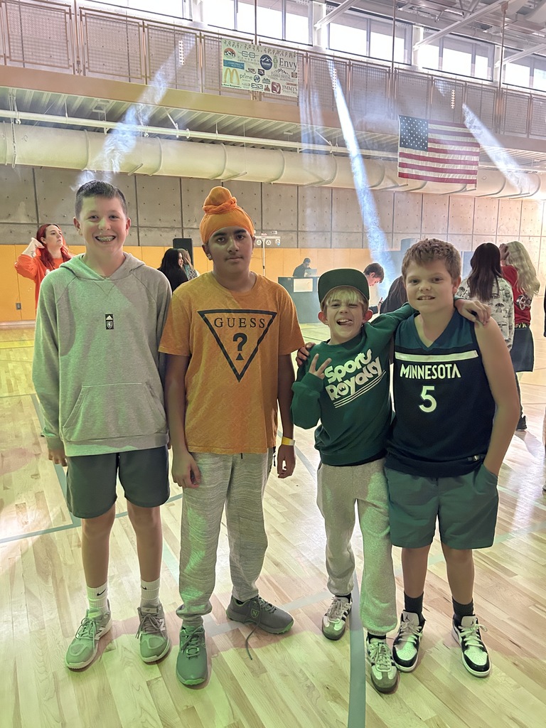 Boys posing at the dance in the gym